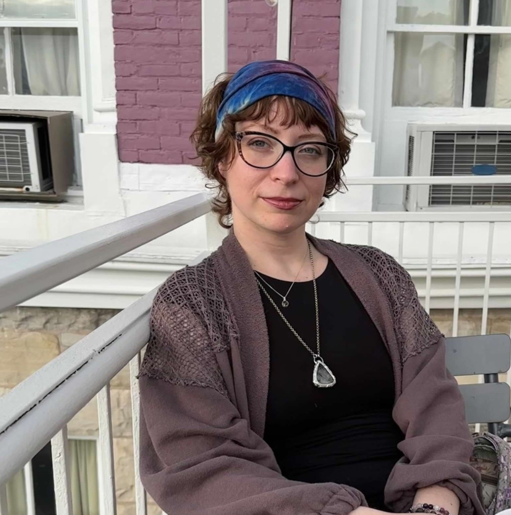Photo of Tracy sitting on a hotel balcony